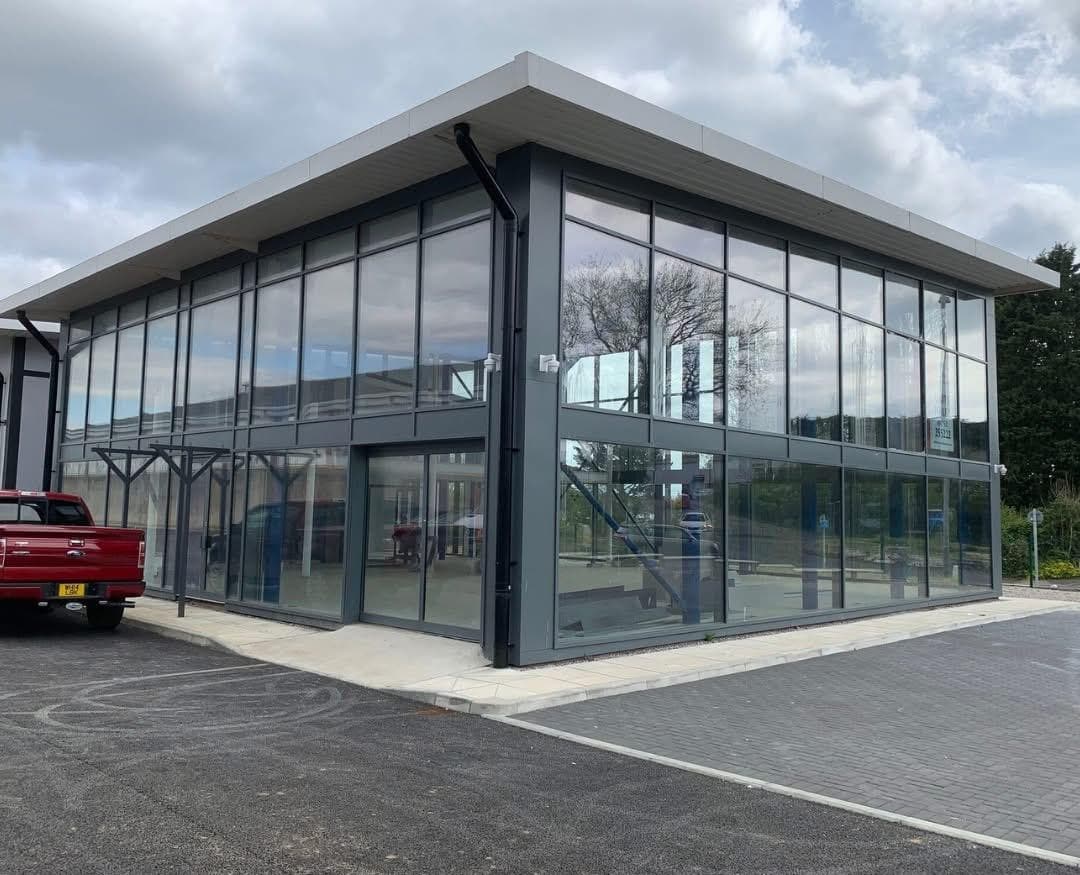 Two-storey commercial office with full-height anthracite curtain walling completed by UK Curtain Walling Ltd